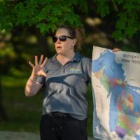 woman holding a map talking outside